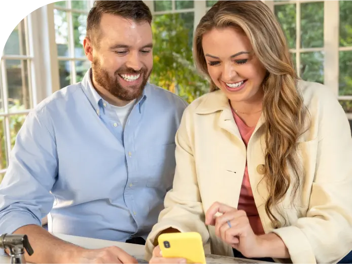 A couple looking at their smart phone