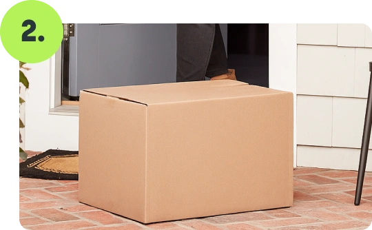 Cardboard delivery box placed on a doorstep for home meal delivery.