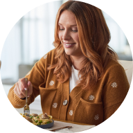 woman smiling and eating