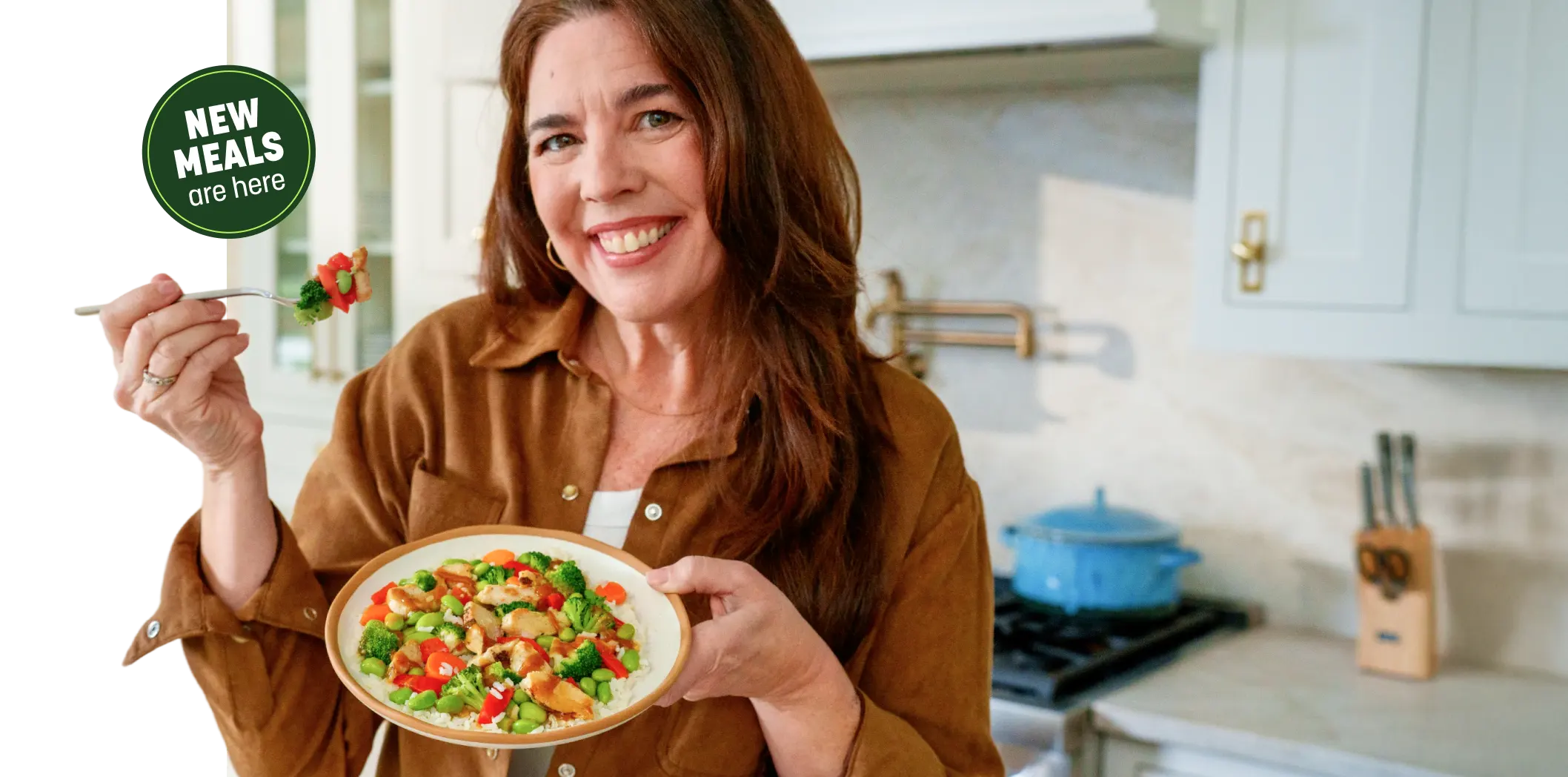 Woman smiling eating chicken and vegetables
