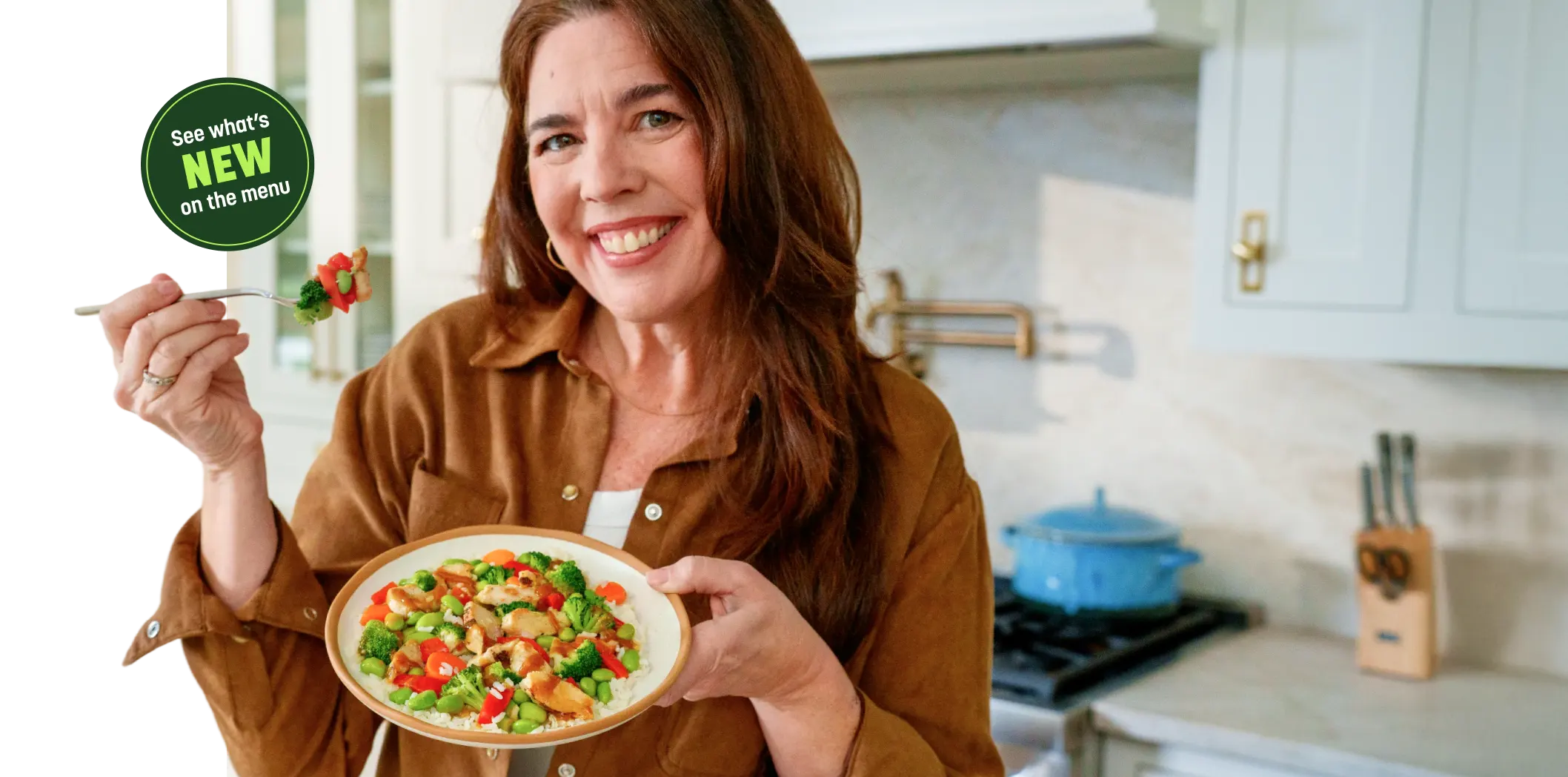 Woman smiling eating chicken and vegetables