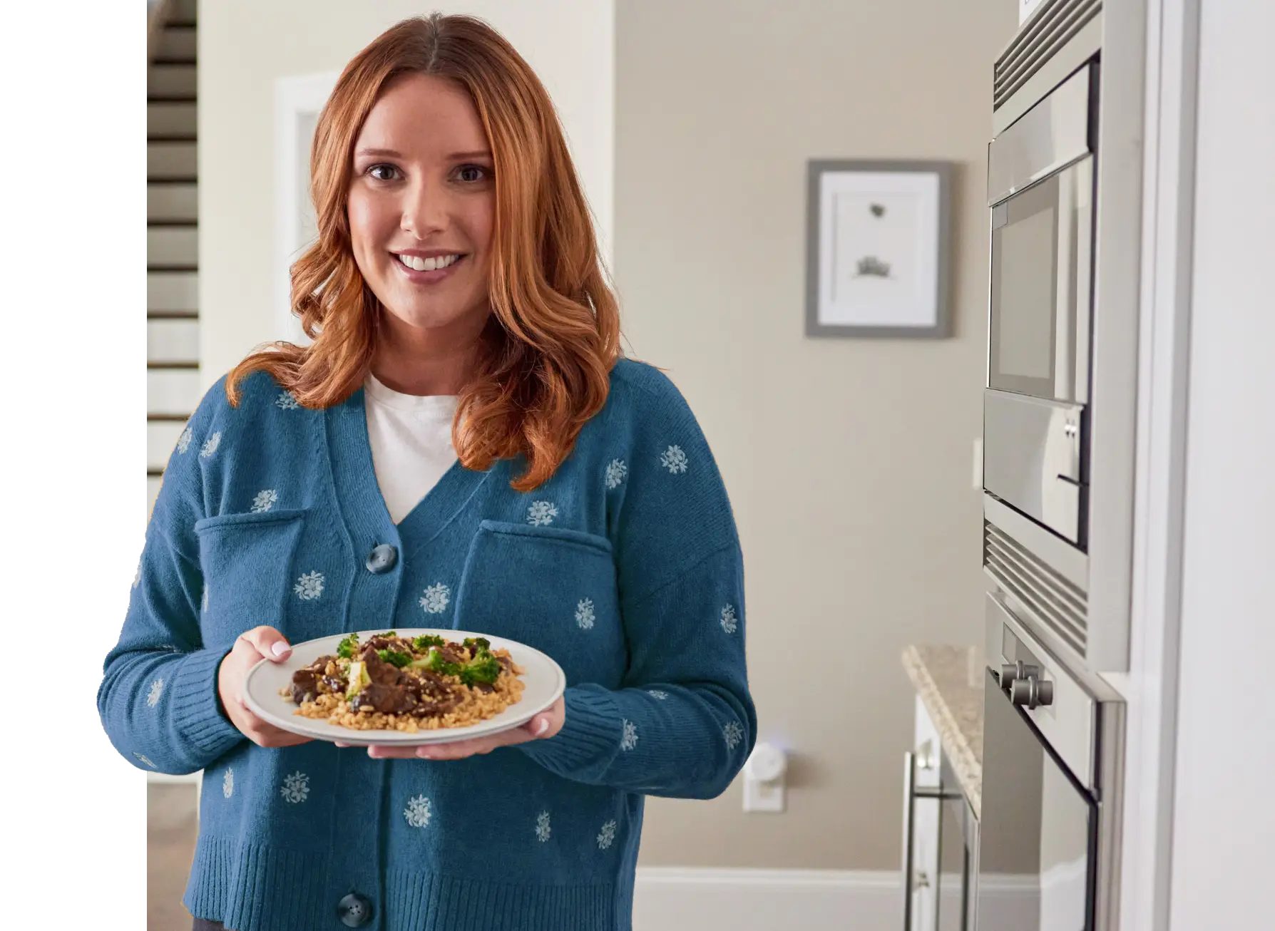 Woman holding plate of Beef and Broccoli